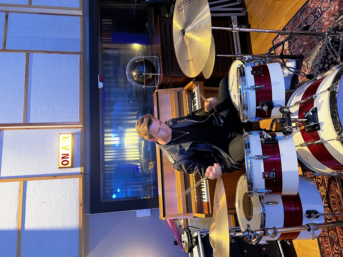 Magnus Murphy playing drums in the studio